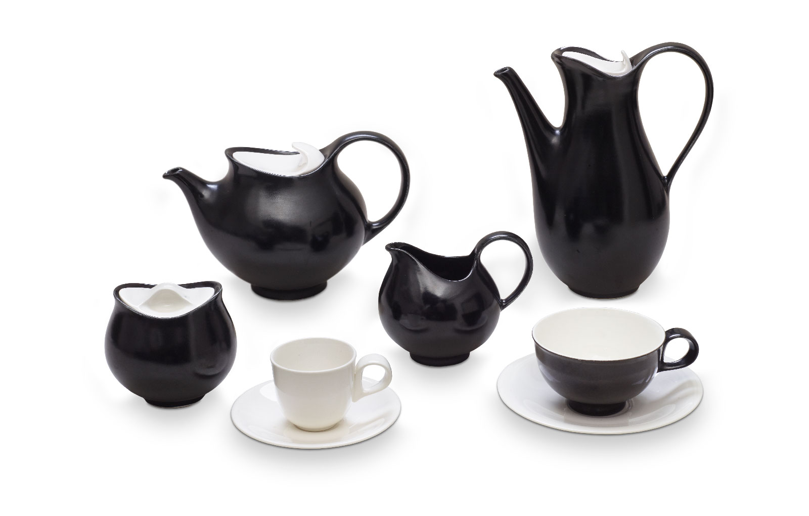 A black-and-white ceramic coffee and tea set arranged in three overlapping rows, with pieces including a teapot, a coffee pot, a sugar bowl, a creamer, a coffee cup with saucer, and a tea cup with saucer
