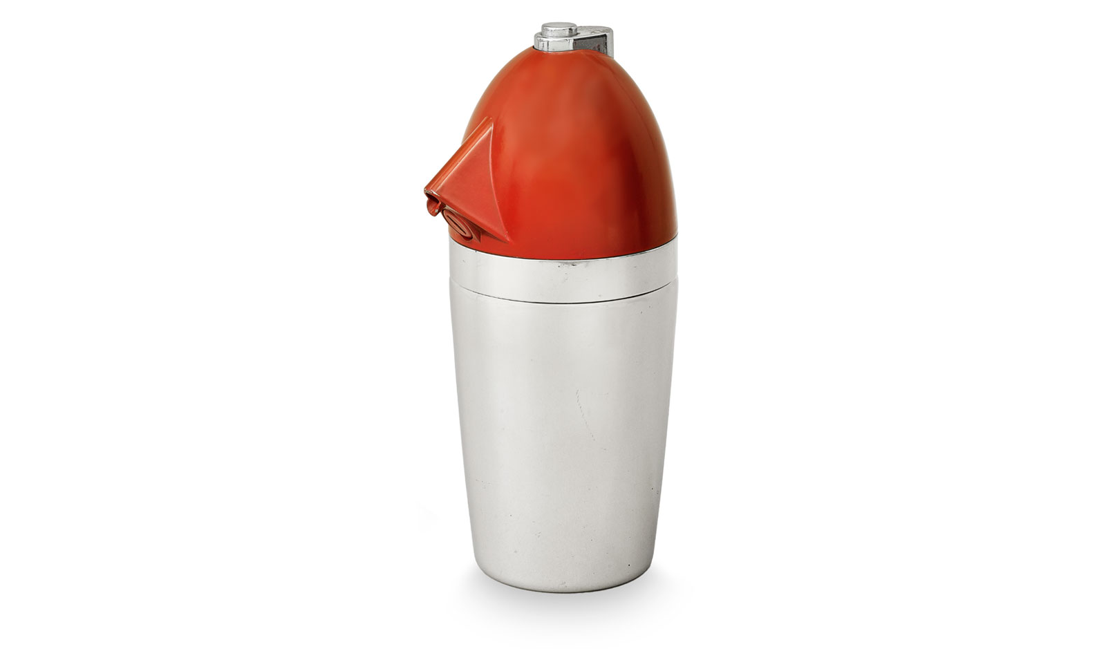 A cocktail shaker with a silver-colored cylindrical base and a red, bullet-shaped top with a spout and a small silver cap